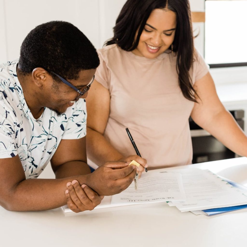 couple signing contract on counter